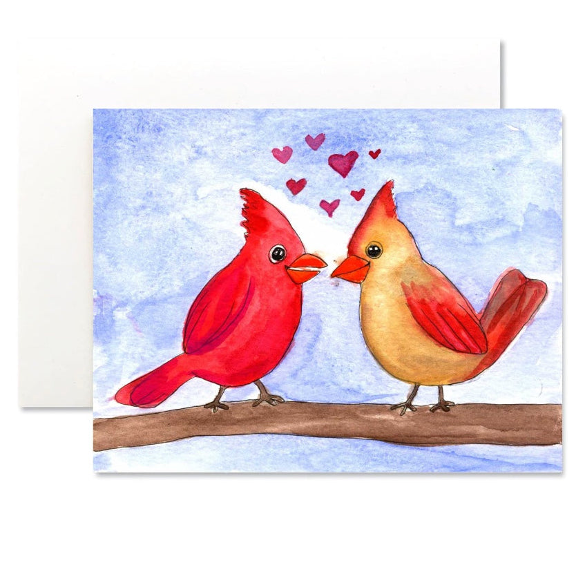Card with two cardinals on a branch and hearts above them against a blue watercolor background