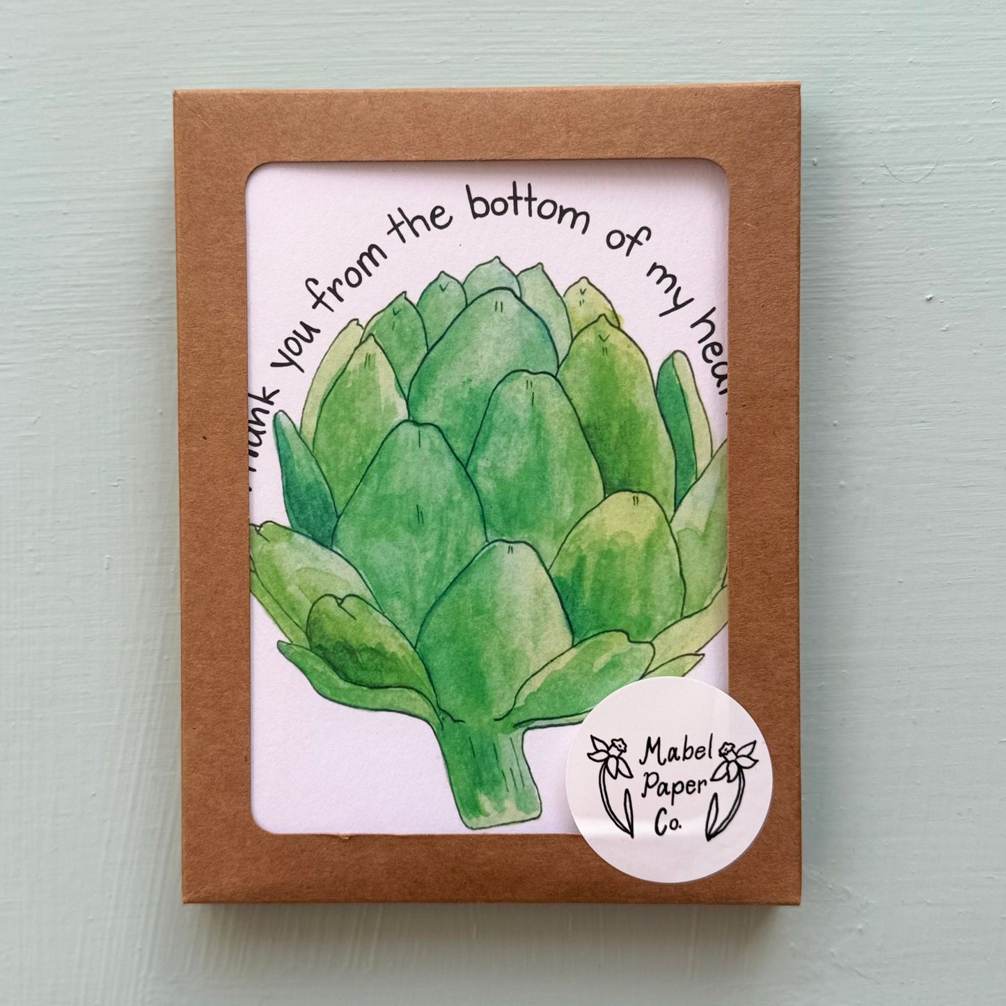 Box set of thank you cards of a green artichoke with text.