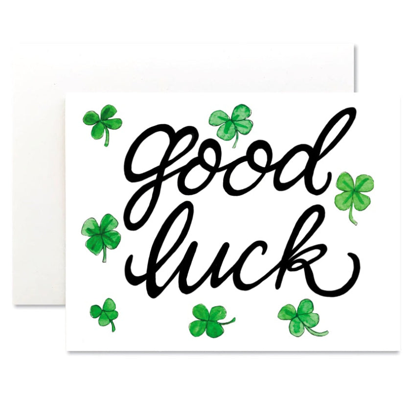 Card with 'Good luck' text and green shamrocks on a white background
